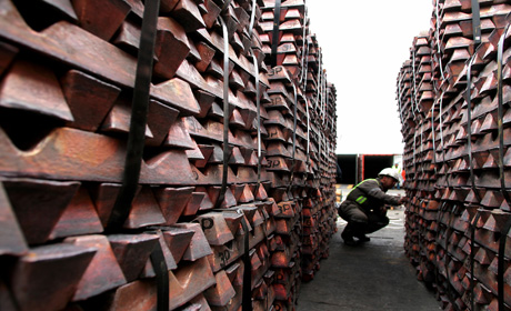 A port worker checks a shipment of copper that is to be exported to Asia in Valparaiso port, Chile